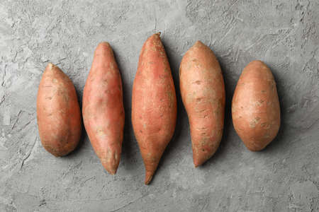 Sweet potato on grey background, top view. Vegetables