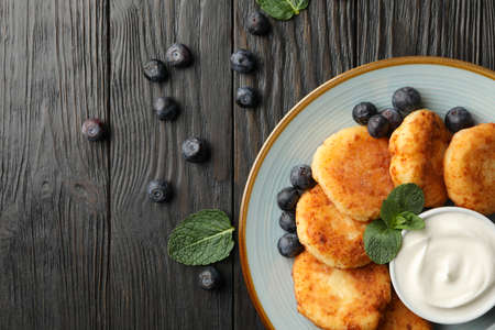 Breakfast of cheese pancakes on wooden background, top viewの写真素材