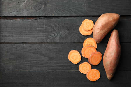 Sweet potato on wooden background, top view. Vegetables