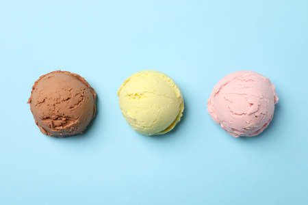 Ice cream balls on blue background, space for textの写真素材