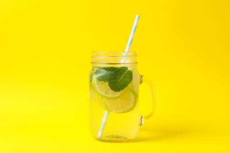 Glass jar with lemonade on yellow background. Fresh drinkの写真素材