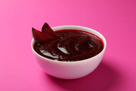 Beet cream soup on pink background, close upの写真素材