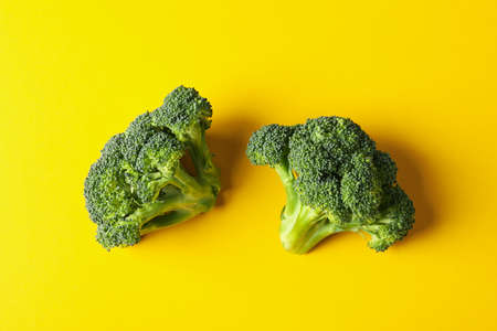Broccoli on yellow background, top view. Healthy foodの写真素材