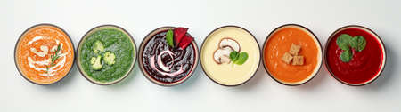 Vegetable soups on white background, top view. Healthy eating
