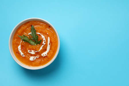 Pumpkin cream soup on blue background, top viewの写真素材