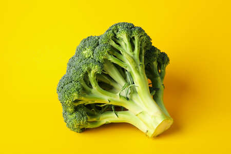 Broccoli on yellow background, close up. Healthy foodの写真素材