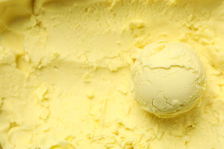 Ice cream ball on yellow background, close upの写真素材