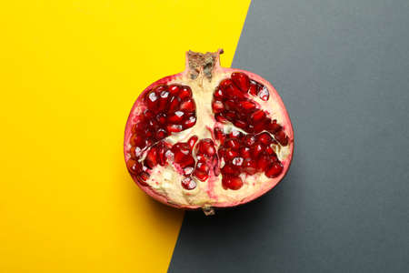 Half of pomegranate on two tone background. Juicy fruitの写真素材