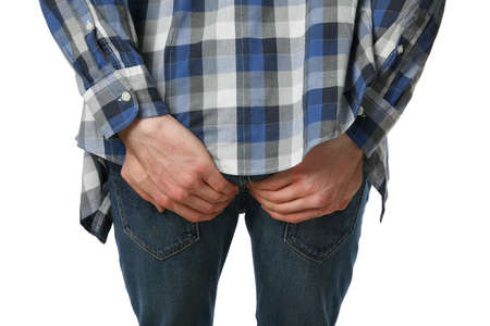 Man holds his ass, isolated on white background. Hemorrhoids