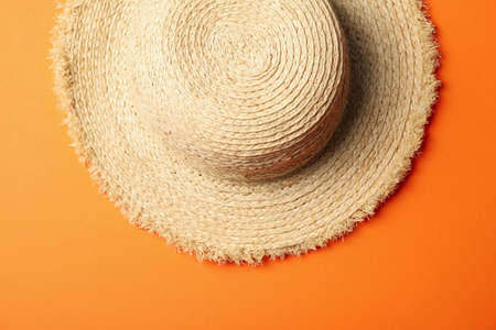 Straw hat on orange background, top viewの写真素材