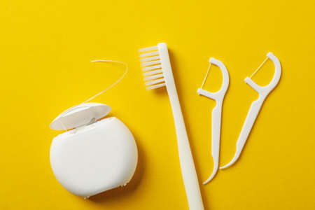 Tools for dental care on yellow background, top viewの写真素材
