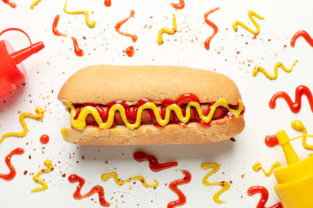 Hot dog and sauces on white background, top viewの写真素材