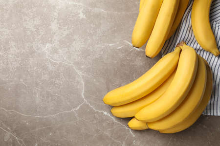 Towel and bananas on gray background. Fresh fruitの写真素材