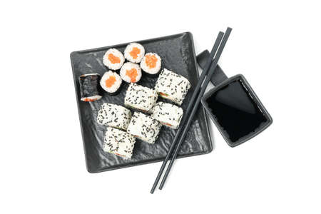 Tray with sushi rolls, chopsticks and soy sauce isolated on white backgroundの写真素材