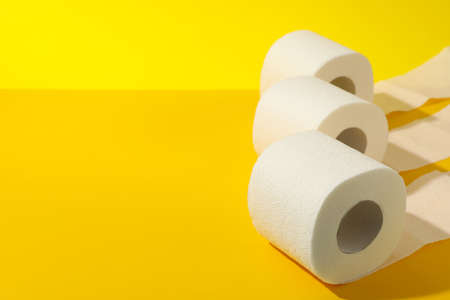 Toilet paper on yellow background, space for textの写真素材