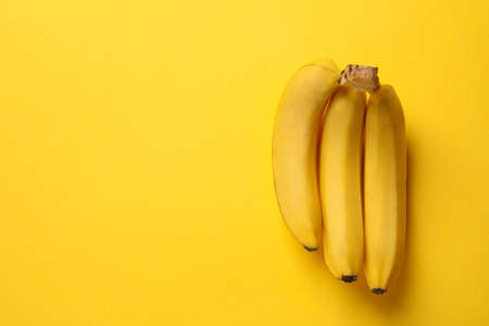 Banana cluster on yellow background. Fresh fruitの写真素材