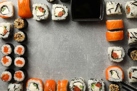 Flat lay with sushi rolls on gray background, space for textの写真素材
