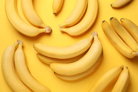 Banana clusters on yellow background. Fresh fruitの写真素材