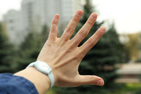 Female hand with clock on blurred backgroundの写真素材