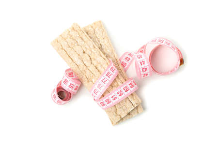 Measuring tape with fitness bread isolated on white backgroundの写真素材