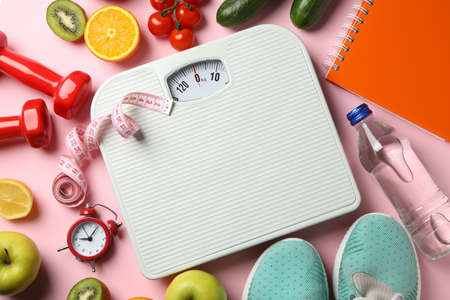 Weight loss or healthy lifestyle accessories on pink backgroundの写真素材