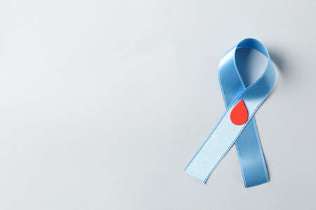 Diabetes. Blue awareness ribbon with decorated blood drop on white backgroundの写真素材
