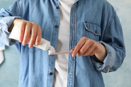 Woman squeezes toothpaste, front view. Dental careの写真素材