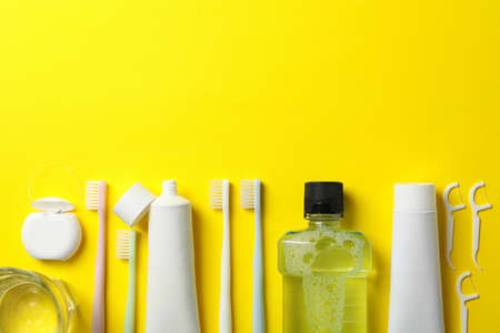 Tools for dental care on yellow background, space for textの写真素材