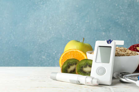 Blood glucose meter and diabetic food on wooden tableの写真素材