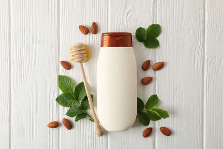 Natural hair care. Blank shampoo bottle and natural ingredients on wooden backgroundの写真素材