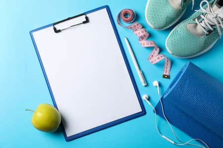 Weight loss or healthy lifestyle accessories on blue backgroundの写真素材