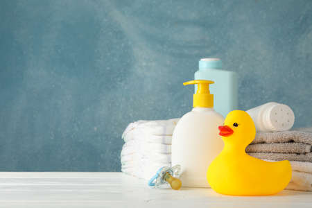 Baby hygiene accessories on wooden table against blue backgroundの写真素材