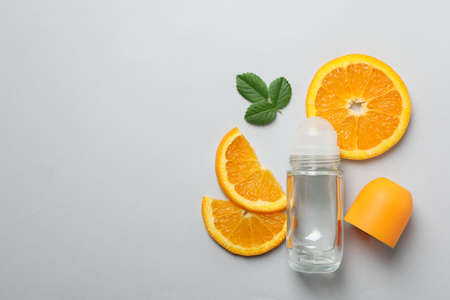 Body deodorant roll-on, leaves and citrus on gray backgroundの写真素材