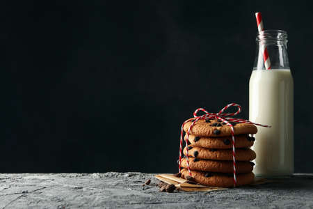 Composition with chip cookies and milk on gray tableの写真素材