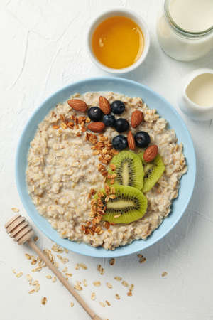Composition with oatmeal with fruits on white backgroundの写真素材