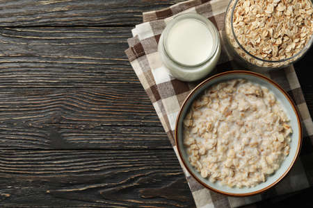 Composition with oatmeal porridge on wooden background. Cooking breakfastの写真素材