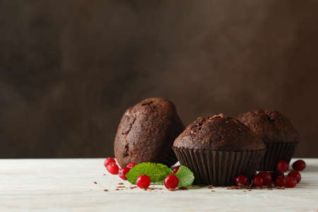 Composition with chocolate muffins and berries on white wooden tableの写真素材