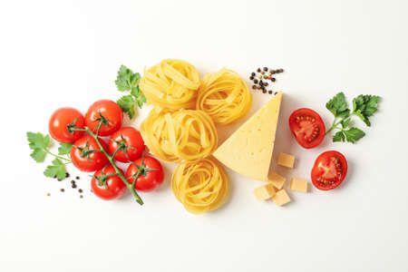 Composition with pasta and ingredients for cooking on white background, top viewの写真素材