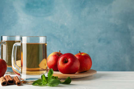 Composition with cider, cinnamon and apples on white wooden backgroundの写真素材