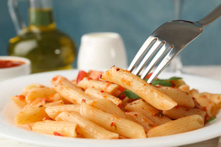 Composition with plate of tasty pasta and fork, close upの写真素材