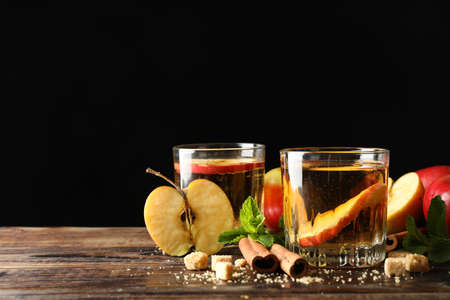 Composition with cider, sugar, cinnamon and apples on wooden tableの写真素材