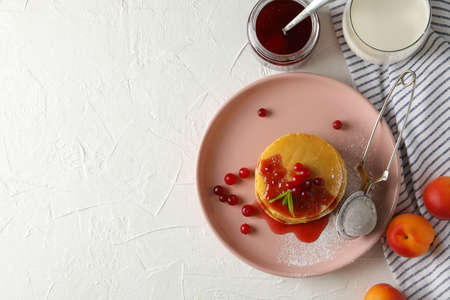 Composition with pancakes with jam and cranberry on white backgroundの写真素材