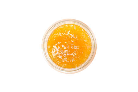 Glass jar with apricot jam isolated on white backgroundの写真素材