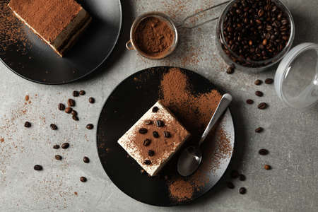Composition with tasty tiramisu and coffee beans on gray backgroundの写真素材