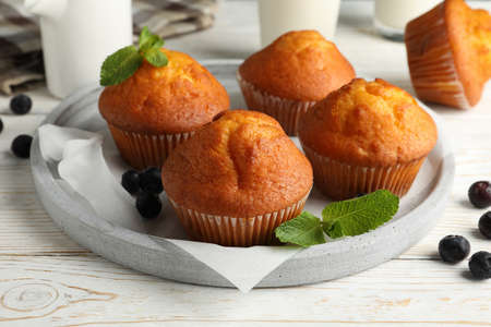 Composition with muffins and milk on white wooden backgroundの写真素材