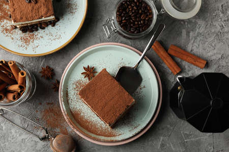 Composition with tiramisu, coffee and cinnamon on gray tableの写真素材