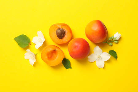 Fresh tasty apricots on yellow background, top viewの写真素材