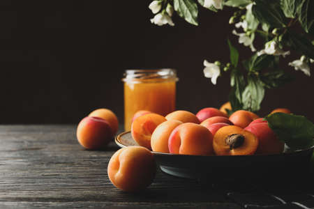 Composition with apricots and jam on wooden backgroundの写真素材