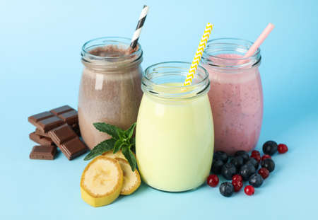 Delicious milkshakes on blue background. Summer drinkの写真素材