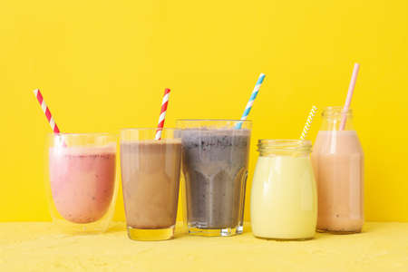 Delicious milkshakes on yellow background. Summer drinkの写真素材